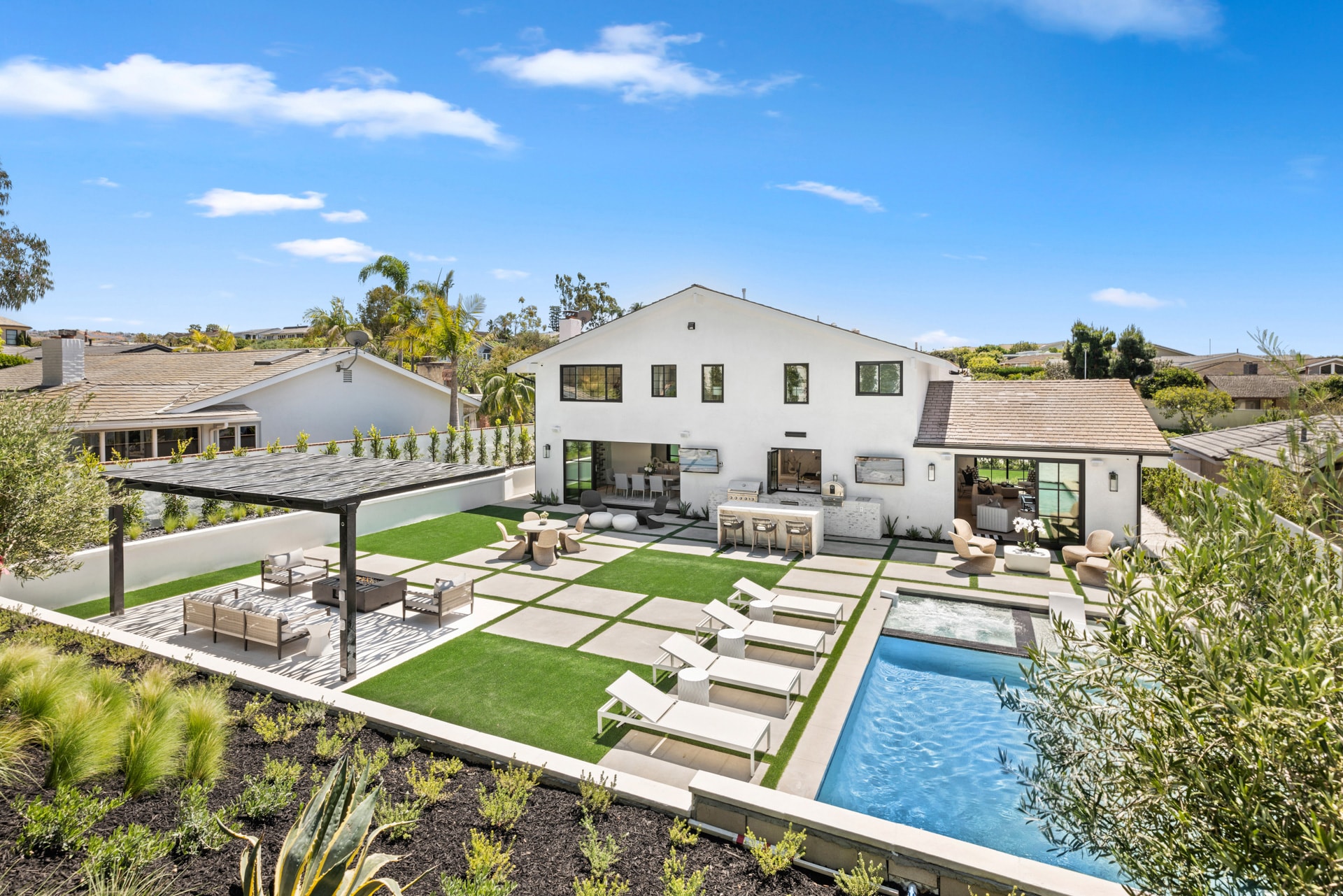 Modern home exterior with pool and landscaped backyard