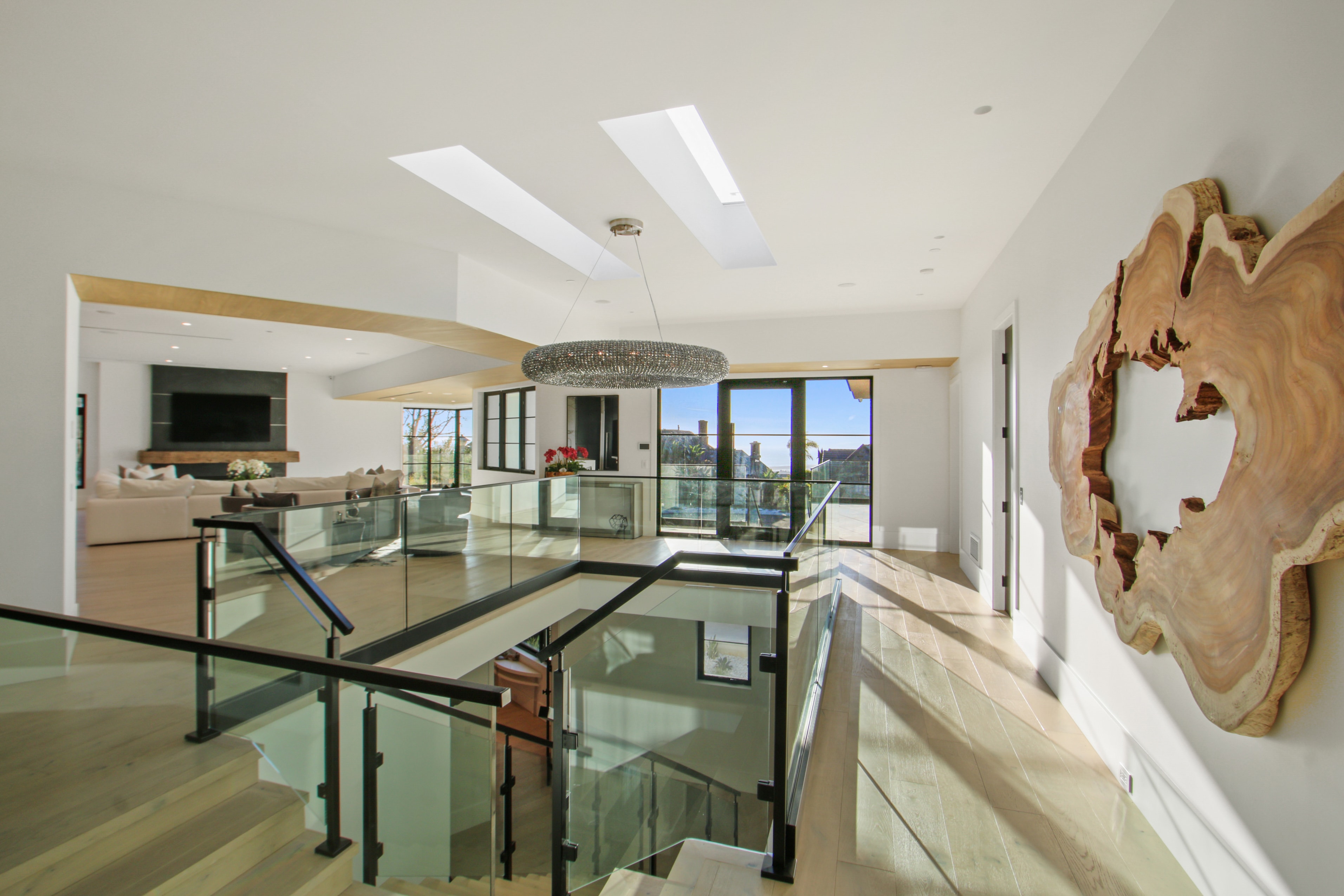 Multi-level interior with glass railings and skylights